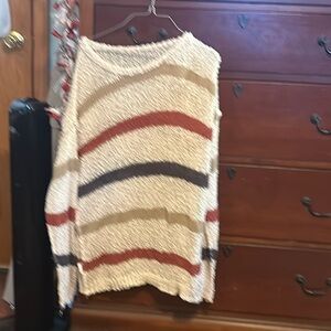 White sweater, striped in tan,red,and black stripes, mesh material